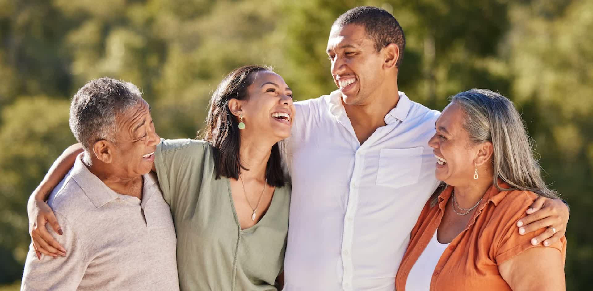 Multi-generational family laughing together outdoors